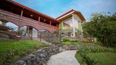 a house with a walkway next to a building at Fondavela Hotel in Monteverde Costa Rica