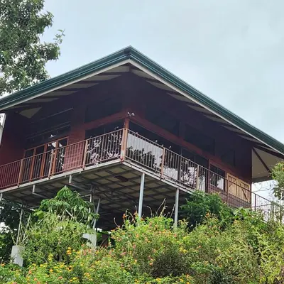 a large house with a balcony on the side of it at Cabaña Vista de Oro 1 in Paraíso