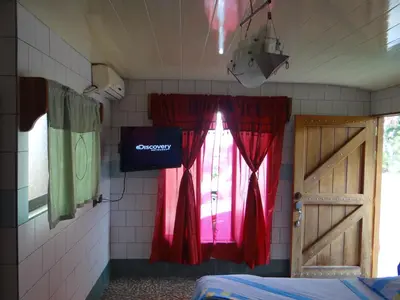 a room with a window with red curtains and a door at Hotel Rosa De Sharon in Marsella