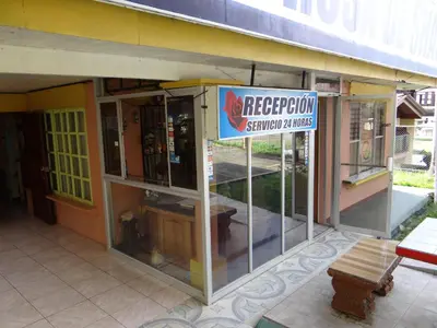 a restaurant with a sign on the side of a building at Hotel Rosa De Sharon in Marsella