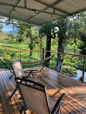 two chairs on a deck with a view of a river at Rincón Sereno San Carlos in La Marina