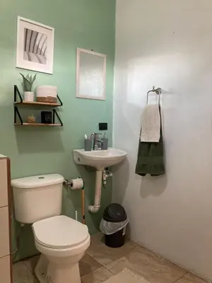 a bathroom with a white toilet and a sink at Rincón Sereno San Carlos in La Marina