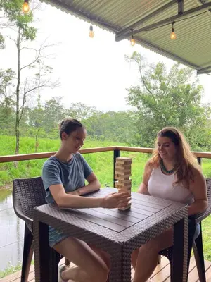 a man and a woman sitting at a table playing a game at Rincón Sereno San Carlos in La Marina