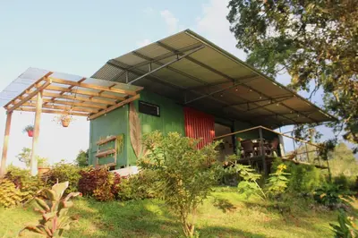 a green and red house with a roof at Rincón Sereno San Carlos in La Marina