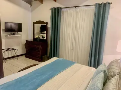 a bedroom with a bed and a dresser and a mirror at Luxury Apt, fully equipped, near to SJO airport in Alajuela City