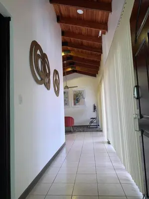 a hallway with a white tile floor and wooden ceilings at Luxury Apt, fully equipped, near to SJO airport in Alajuela City