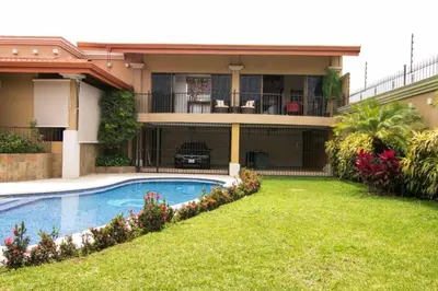 a house with a swimming pool in the yard at Luxury Apt, fully equipped, near to SJO airport in Alajuela City
