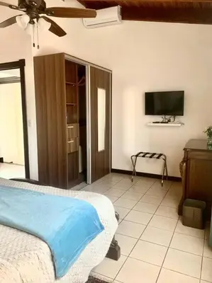 a bedroom with a bed and a flat screen tv at Luxury Apt, fully equipped, near to SJO airport in Alajuela City