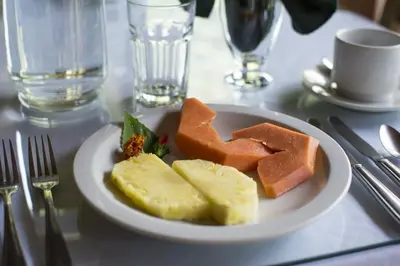 a plate of food with fruit on a table at Bosque de Paz Reserva Biologica in Toro Amarillo
