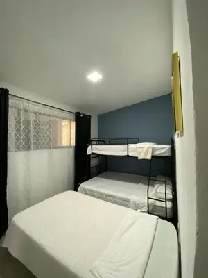 a bedroom with two bunk beds and a window at Tranquilo, Central y acogedor in San José