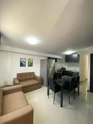 a living room with a couch and a table and chairs at Tranquilo, Central y acogedor in San José