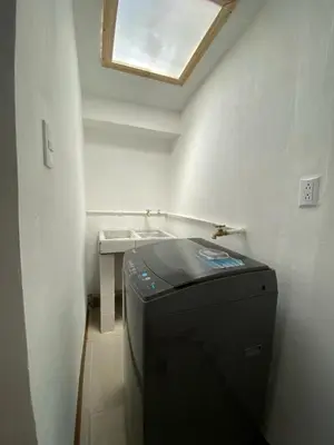 a small white room with a sink and a window at Tranquilo, Central y acogedor in San José