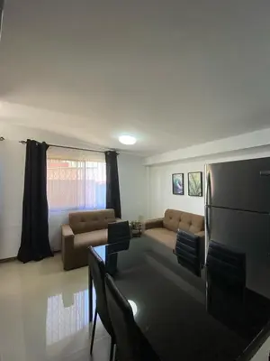 a living room with a couch and a table at Tranquilo, Central y acogedor in San José