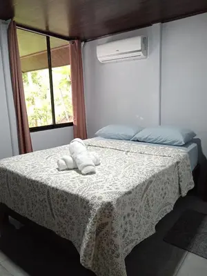 a bedroom with a bed with towels on it at Casa La Montaña in Sámara