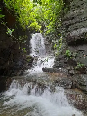 a waterfall in the middle of a river at Tinamaste in Uvita