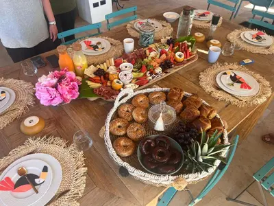 a wooden table topped with a table full of food at Tinamaste in Uvita