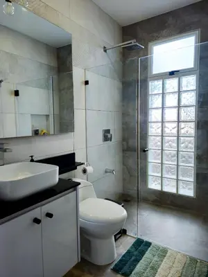 a bathroom with a toilet and a sink and a shower at Casa Frangipani in Santa Rosa de Tamarindo in Santa Cruz
