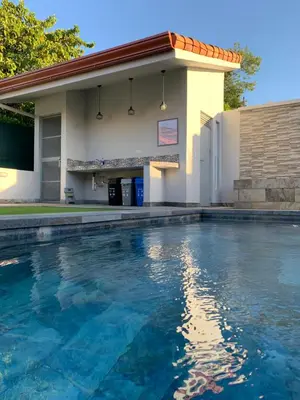 a swimming pool in front of a building at Casa Frangipani in Santa Rosa de Tamarindo in Santa Cruz