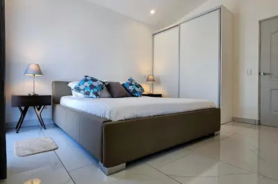 a bedroom with a bed with two pillows on it at Casa Frangipani in Santa Rosa de Tamarindo in Santa Cruz