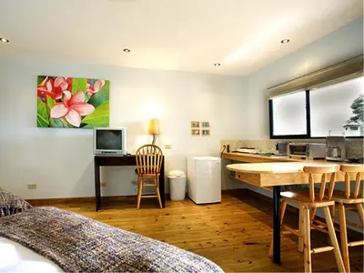 a kitchen with a table and a desk in a room at Out of Bounds Boutique Hotel in San José