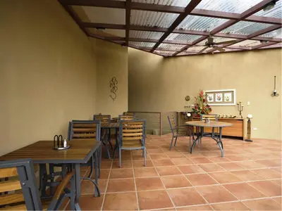 a restaurant with tables and chairs in a room at Out of Bounds Boutique Hotel in San José