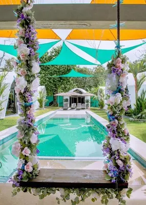 a swimming pool with flowers and a tent at Alborada Boutique Stay in Uvita