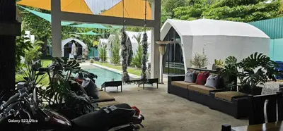 a patio with plants and a swimming pool at Alborada Boutique Stay in Uvita