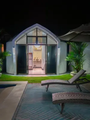 a house with two chairs and an umbrella at Alborada Boutique Stay in Uvita