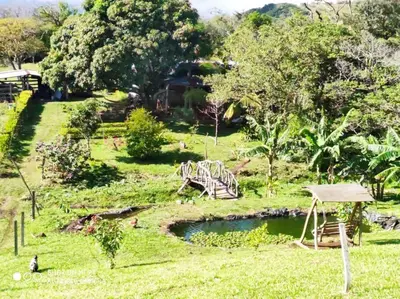 a park with a playground and a pond in the grass at Casa Luz de Luna in Paraíso