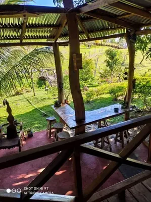 a view of a porch with a table and benches at Casa Luz de Luna in Paraíso