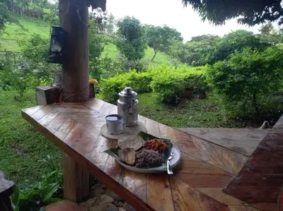 a table with a plate of food on a wooden table at Casa Luz de Luna in Paraíso