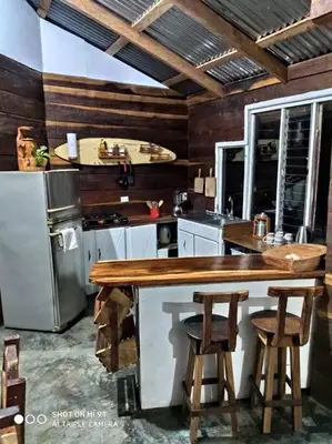 a kitchen with a wooden counter and a refrigerator at Casa Luz de Luna in Paraíso