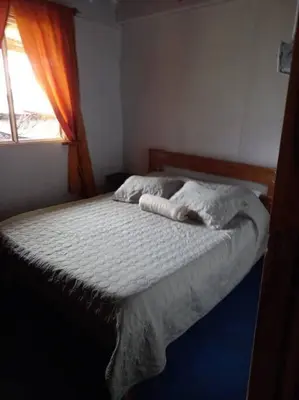 a bed in a bedroom with a window at Casa Luz de Luna in Paraíso