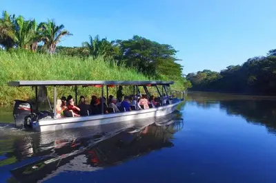 a group of people riding on a boat on a river at Guaitil Chorotega House, acogedora y tranquila in Santa Cruz