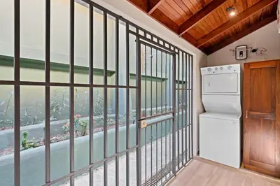 a kitchen with a balcony with a view of the water at Stylish 2-Bedroom Beach Condo with Ocean-View Deck, Lush Pool Area & 2-Minute Walk to Flamingo Beach in Playa Flamingo
