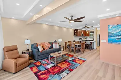 a living room with a couch and a table at Stylish 2-Bedroom Beach Condo with Ocean-View Deck, Lush Pool Area & 2-Minute Walk to Flamingo Beach in Playa Flamingo