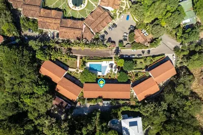 an overhead view of a house with a swimming pool at Stylish 2-Bedroom Beach Condo with Ocean-View Deck, Lush Pool Area & 2-Minute Walk to Flamingo Beach in Playa Flamingo