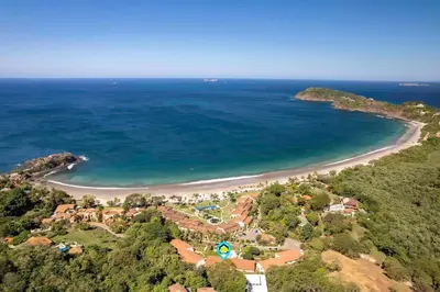 an aerial view of a resort and a beach at Stylish 2-Bedroom Beach Condo with Ocean-View Deck, Lush Pool Area & 2-Minute Walk to Flamingo Beach in Playa Flamingo
