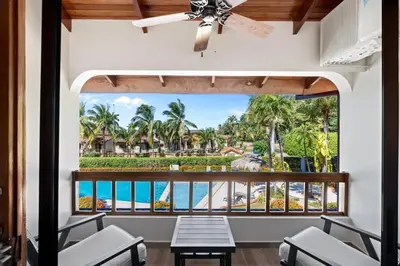 a balcony with a view of the ocean at Stylish 2-Bedroom Beach Condo with Ocean-View Deck, Lush Pool Area & 2-Minute Walk to Flamingo Beach in Playa Flamingo
