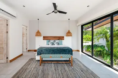 a bedroom with a bed and large windows at Beachside Bliss 4BR Lux Villa, Pool, Terrace, Golf in San José Pinilla