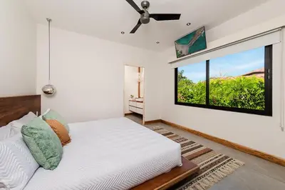 a bedroom with a bed and a large window at Beachside Bliss 4BR Lux Villa, Pool, Terrace, Golf in San José Pinilla