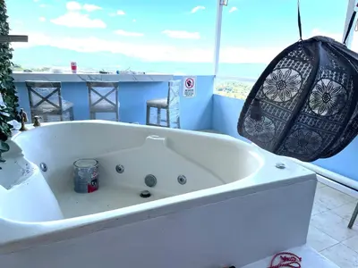 a white bath tub in a bathroom with a view at Cabaña2 Mirador Jacuzzi in Sarchí