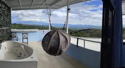 a bathroom with a bath tub on a balcony at Cabaña2 Mirador Jacuzzi in Sarchí