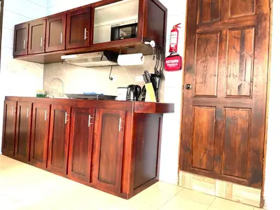 a kitchen with wooden cabinets and a door at Cabaña2 Mirador Jacuzzi in Sarchí