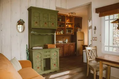 a green cabinet in a living room with a kitchen at Cabin at Los Titos Coffee Farm in Recreo