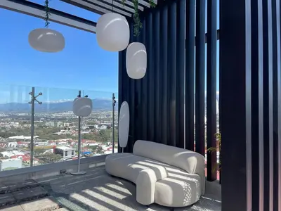 a white couch in a room with a large window at SkyGarden Nunciatura Luxury Apartment #705 in San José