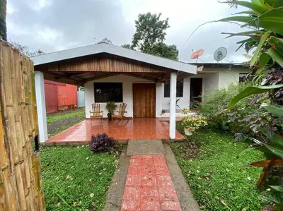 a small house with a porch and a patio at Jardín Del Bosque in Bijagua