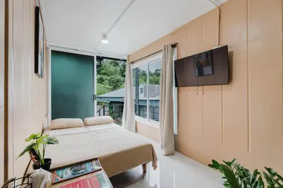a room with a bed and a tv on a wall at Ronnys Flat Manuel Antonio in Quepos