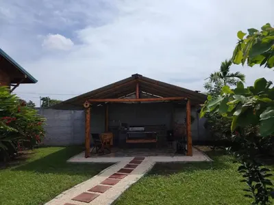 a wooden pavilion with a table in a yard at Cabaña la Corteza in Tanque