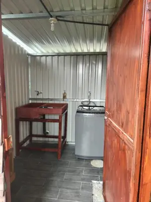 a bathroom with a sink and a washing machine at Cabaña la Corteza in Tanque
